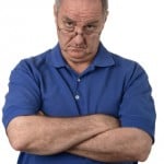 Man with folder arms, scolding look