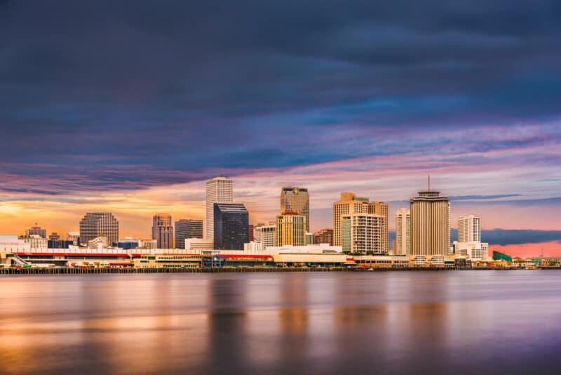New Orleans, Louisiana, USA downtown city skyline on the Mississippi River at sunset.