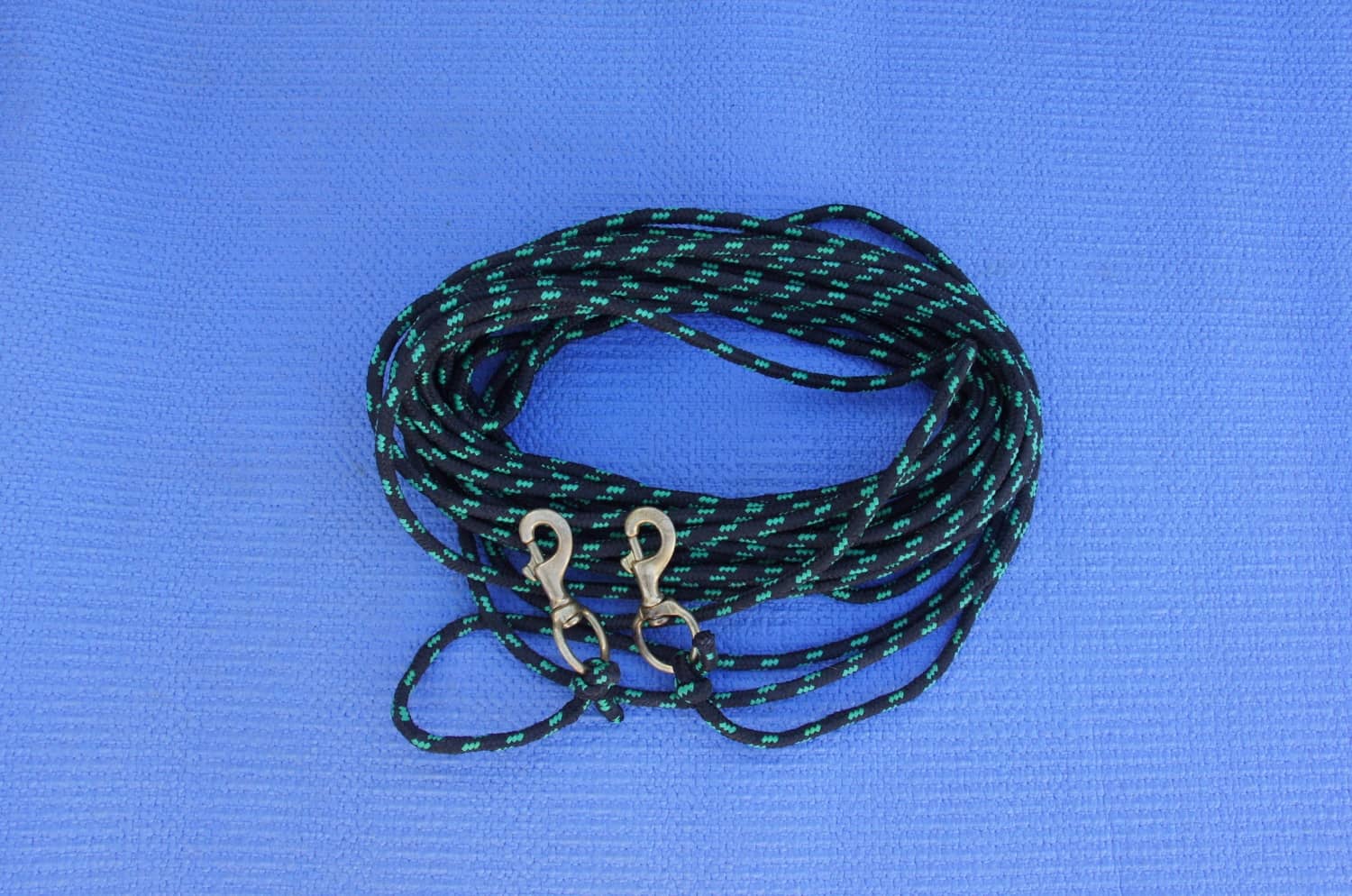 Coiled rope with snap clips attached to each end