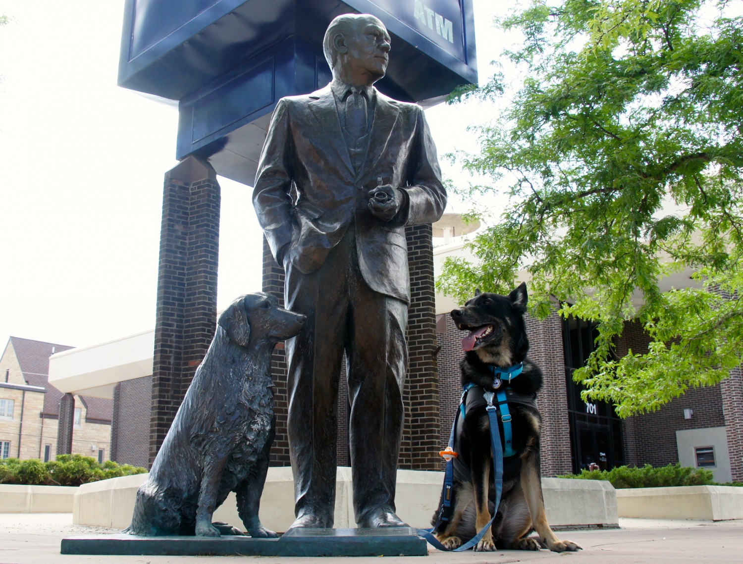 Black German Shepherd posing with President Ford statue in Rapid City, South Dakota