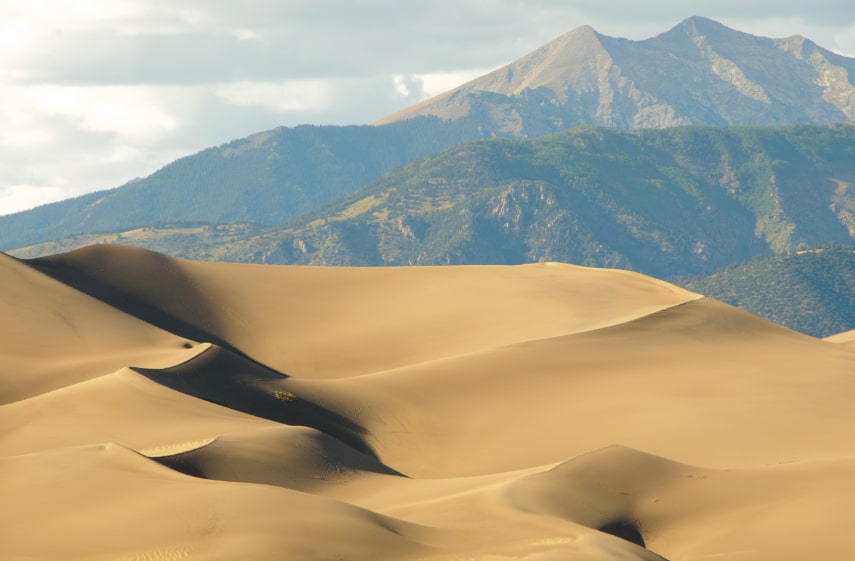 Sand dunes with mountains in the background at pet-friendly Great Sand Dunes National Park, Colorado