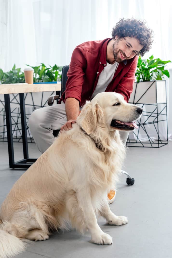 Man and dog drinking coffee at a dog-friendly cafe in San Diego