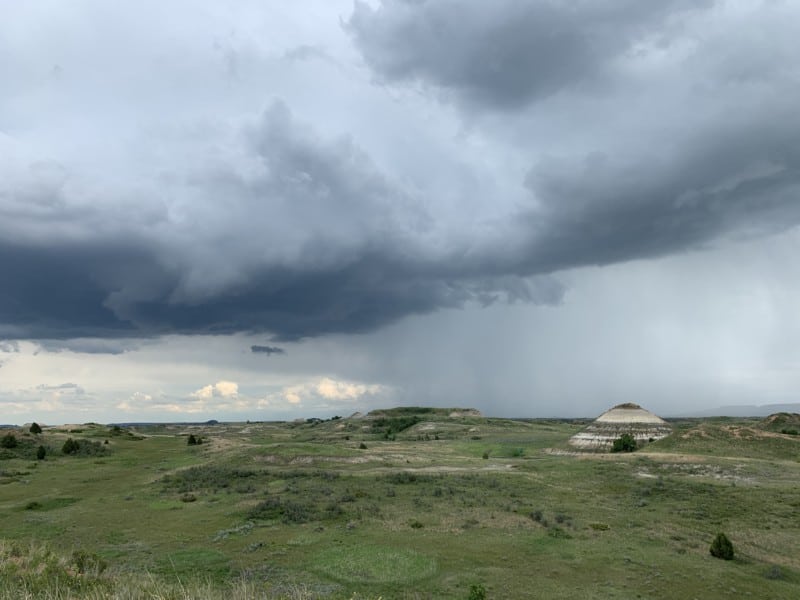 Grassy badlands under a cloudy sky in western North Dakota