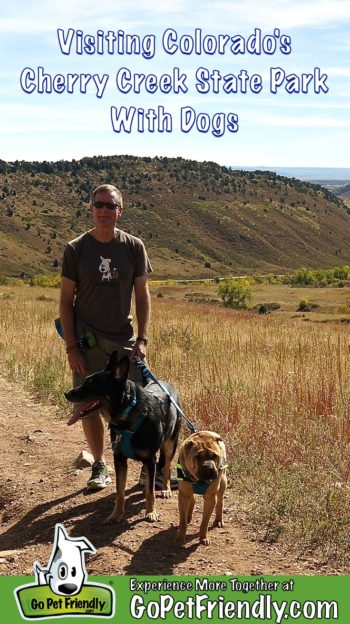 Man with two dogs on a pet friendly trail in Cherry Creek State Park in Colorado