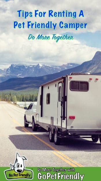 Truck and Pet Friendly Camper on highway heading toward snow-covered mountains