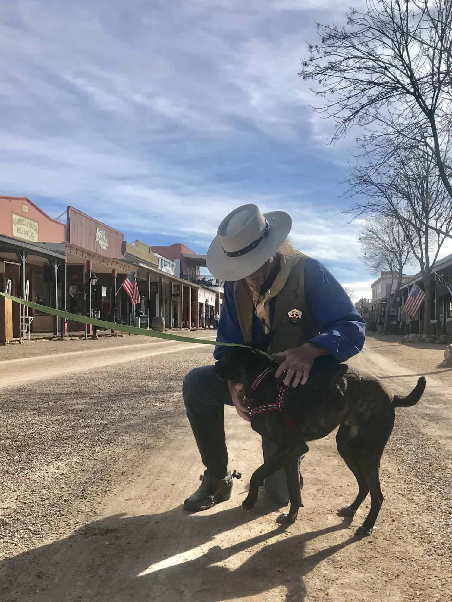 Deputy petting a bridle dog in Tombstone, AZ