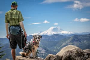 Man and his dog enjoying the view of Mt. Rainier from pet-friendly Ira Spring Trail near Seattle, WA