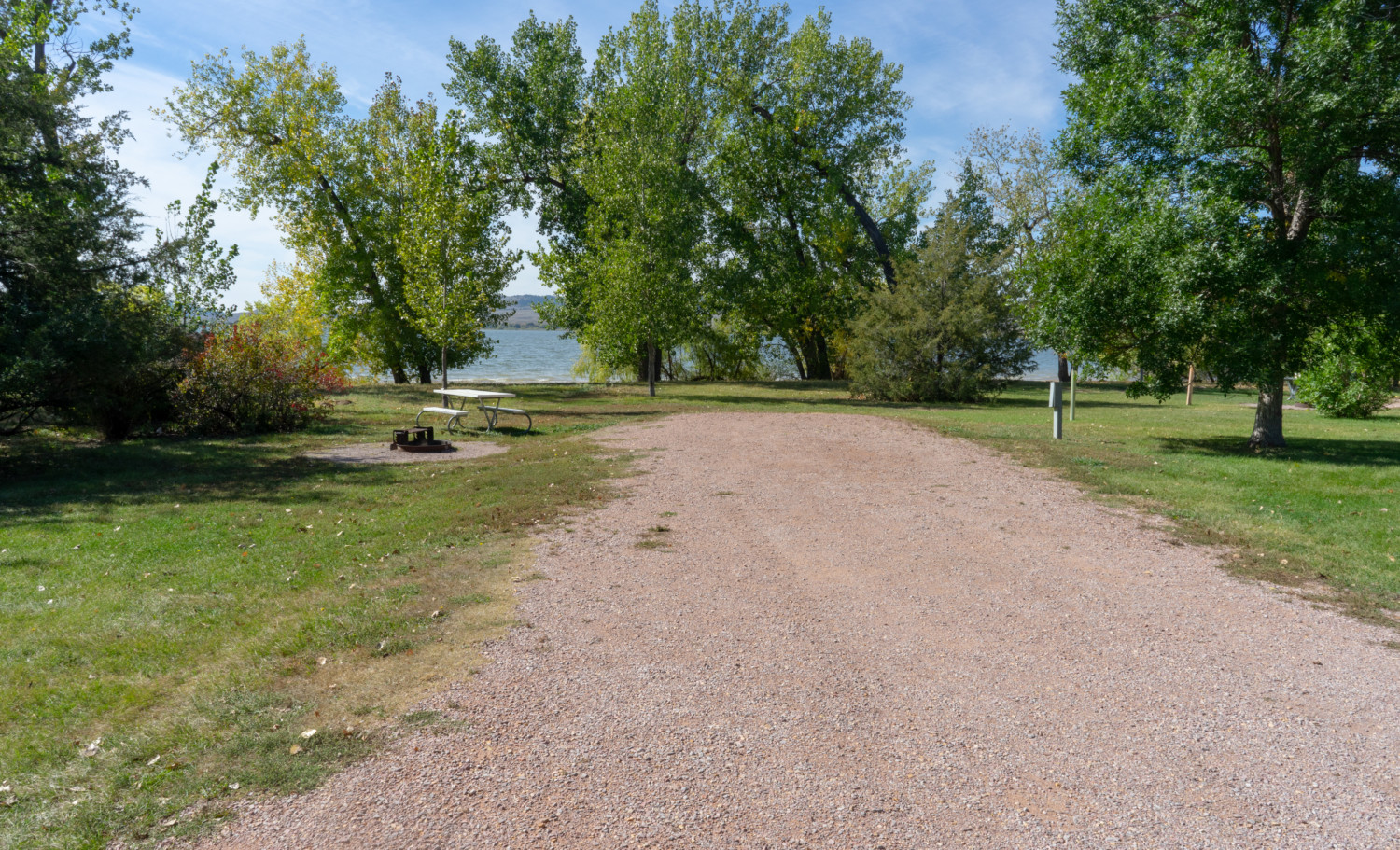 A campsite backing up to the beach at pet-friendly Angostura Reservoir in South Dakota's Black Hills