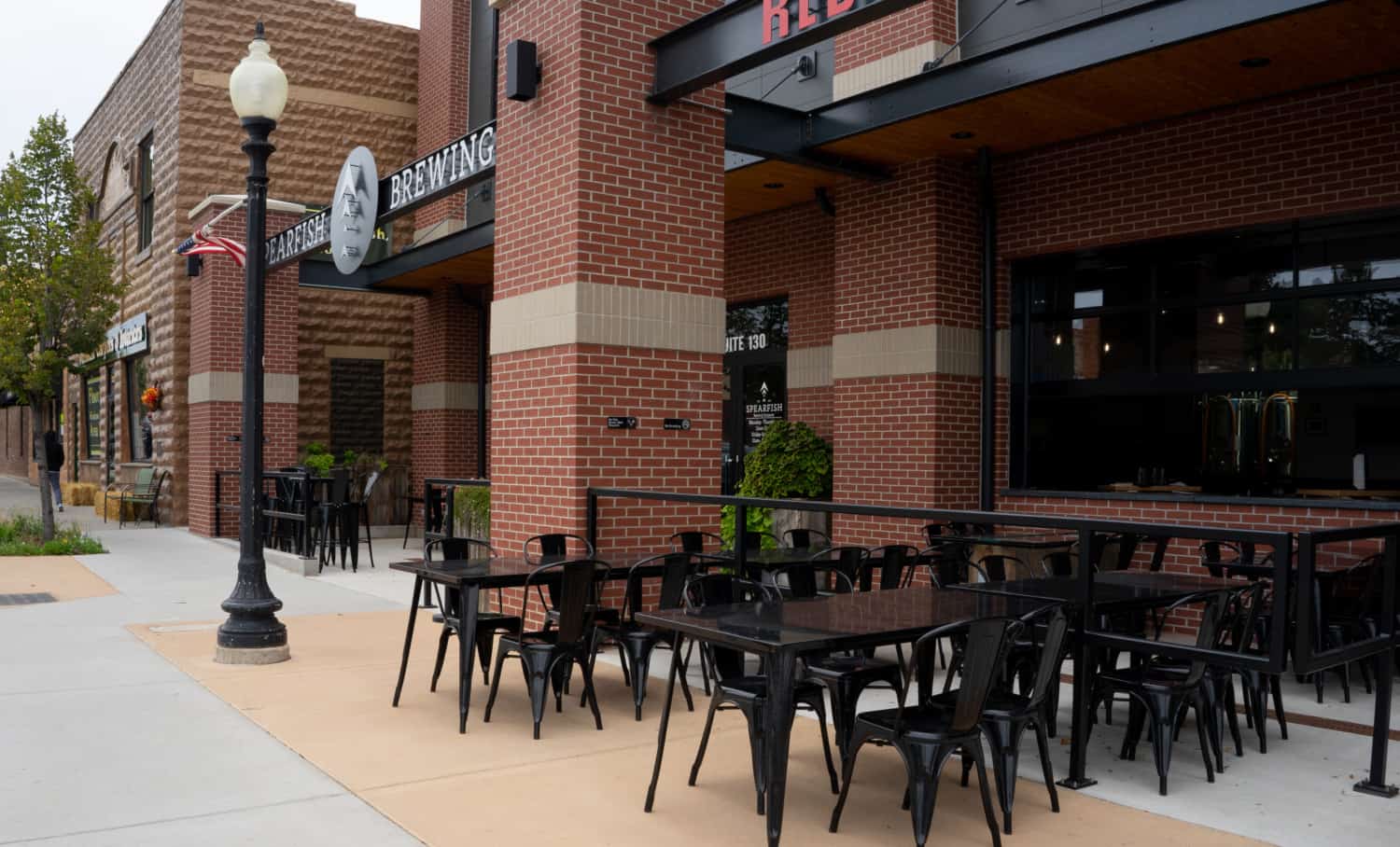 Front entrance to Spearfish Brewing Company in Spearfish, SD, showing the outside seating area