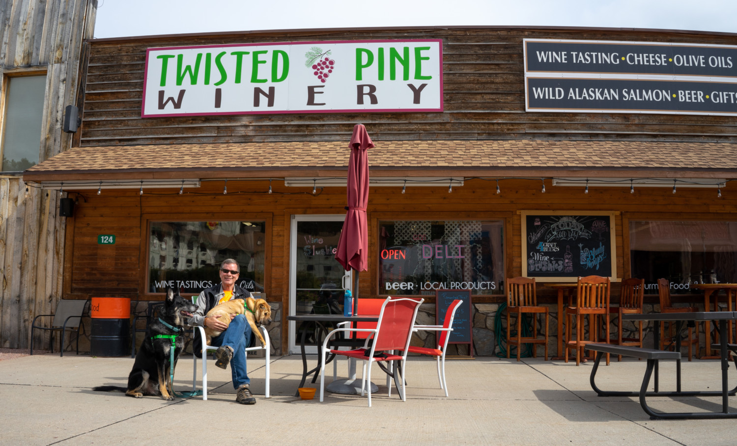 Rod, Buster, and Ty from GoPetFriendly.com at the pet-friendly sidewalk seating area at Twisted Pine Winery in Hill City, SD