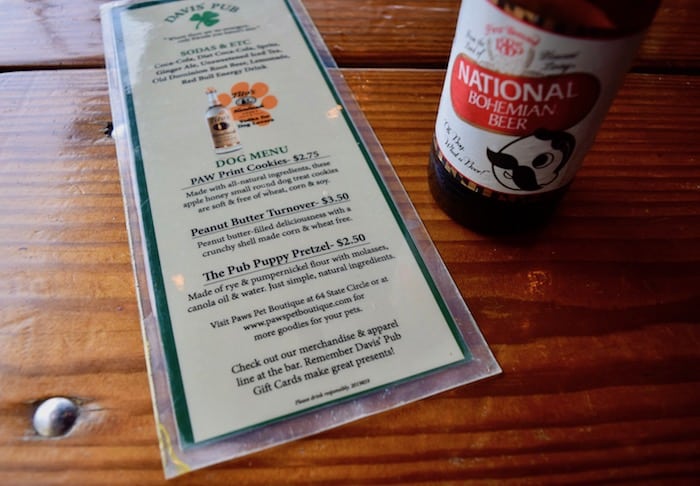 Davis's Pub in Annapolis's pet-friendly Eastport neighborhood offers a menu for dog diners! (Dog menu beside beer bottle.)