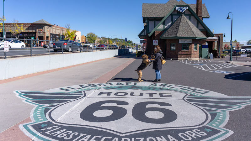 Woman and dog admiring the Route 66 Street Art at the pet-friendly Flagstaff Visitor Center in Arizona