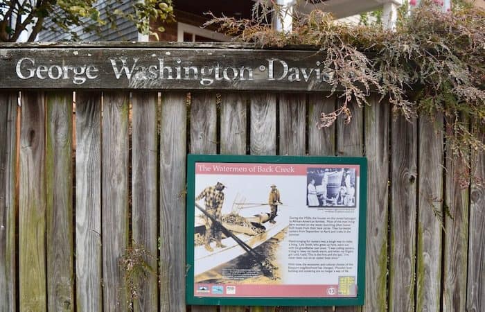 George Washington Davis park sign in pet-friendly Annapolis describing the history of black watermen who worked in the area.