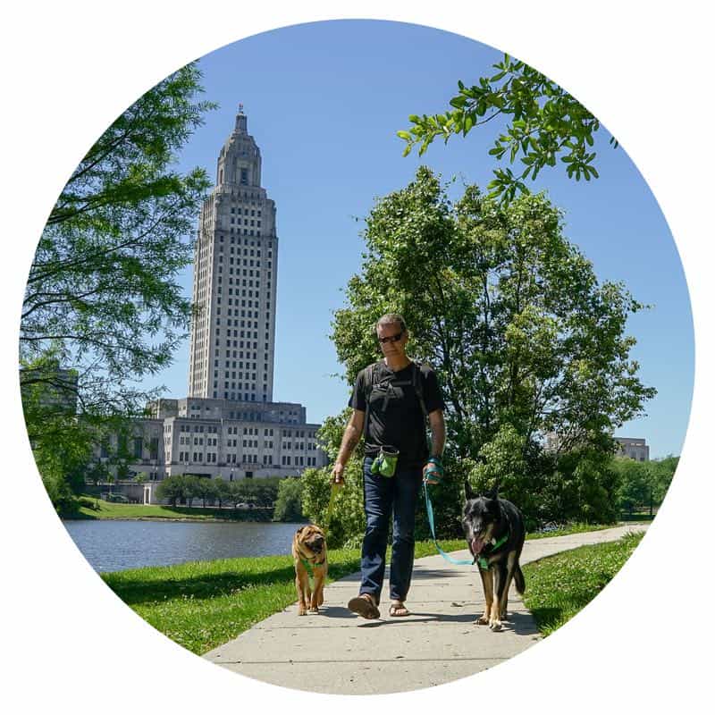 Rod, Ty, and Buster from GoPetFriendly.com walking the pet-friendly trails around the LA Capitol Building in Baton Rouge