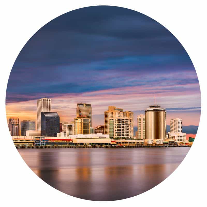 New Orleans, LA skyline at evening with the Mississippi River in the foreground