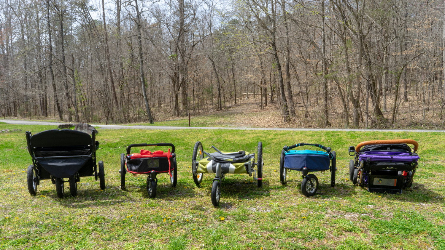 Five dog strollers in a the folded position for comparison