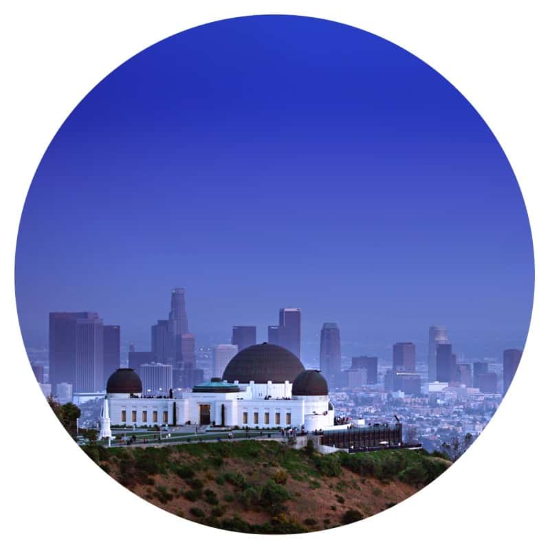 Photo taken from a pet friendly trail of Griffith Park Observatory with the Los Angeles skyline in the background.