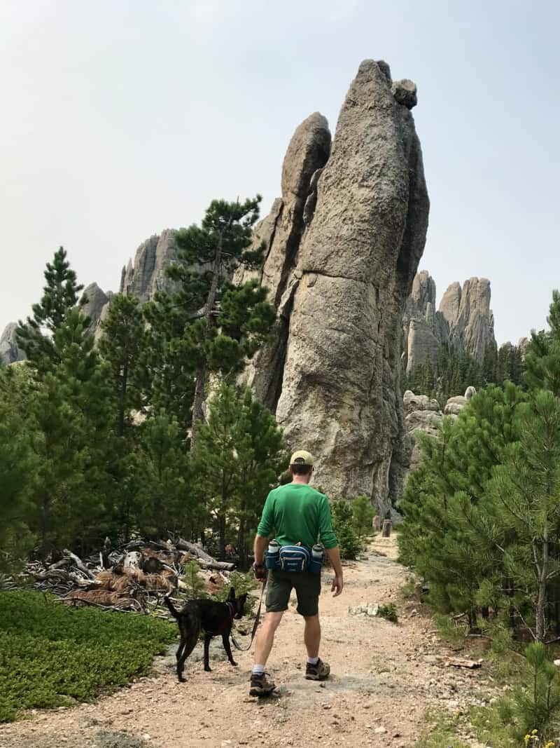 Man and dog walking pet friendly Trail #4 in Custer State Park, South Dakota