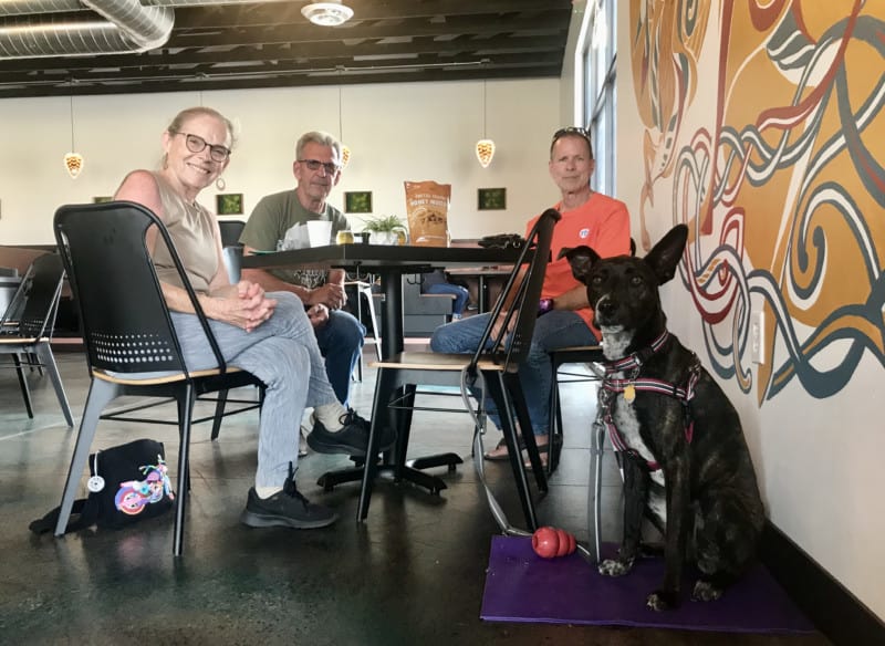 A woman, two men, and a dog at the pet friendly tap room at Cohort Craft Brewery in Rapid City, SD