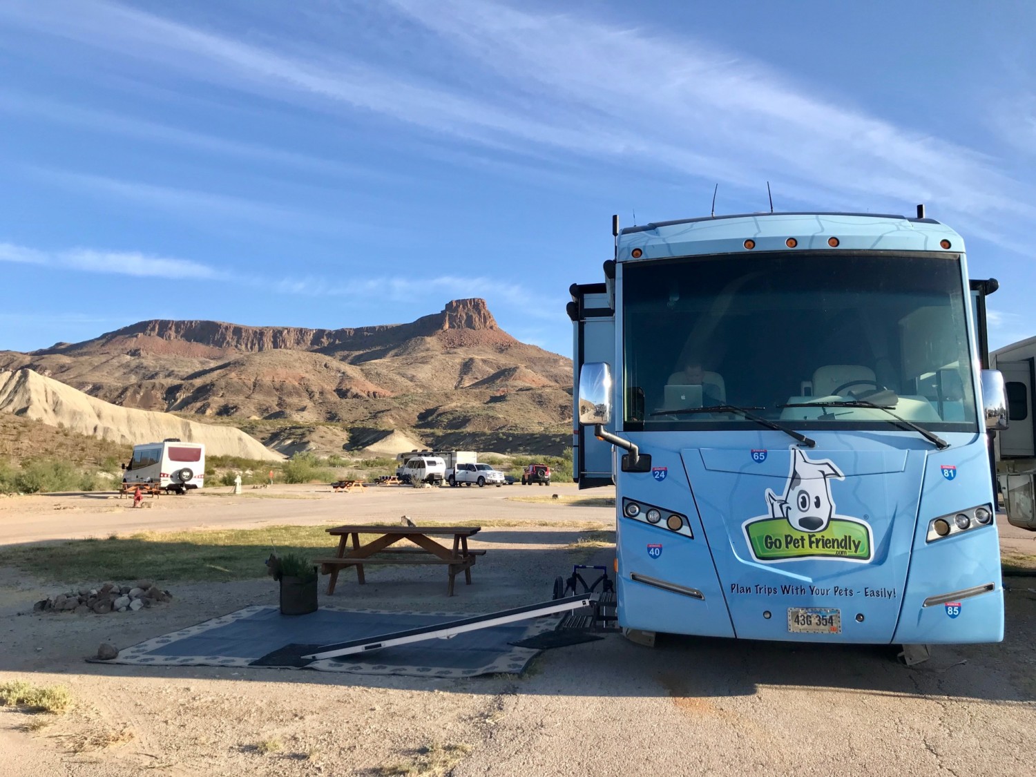 Motorhome featuring a dog ramp with slip resistant surface. RV is parked at dog friendly Maverick Ranch RV Park in Lajitas, Texas