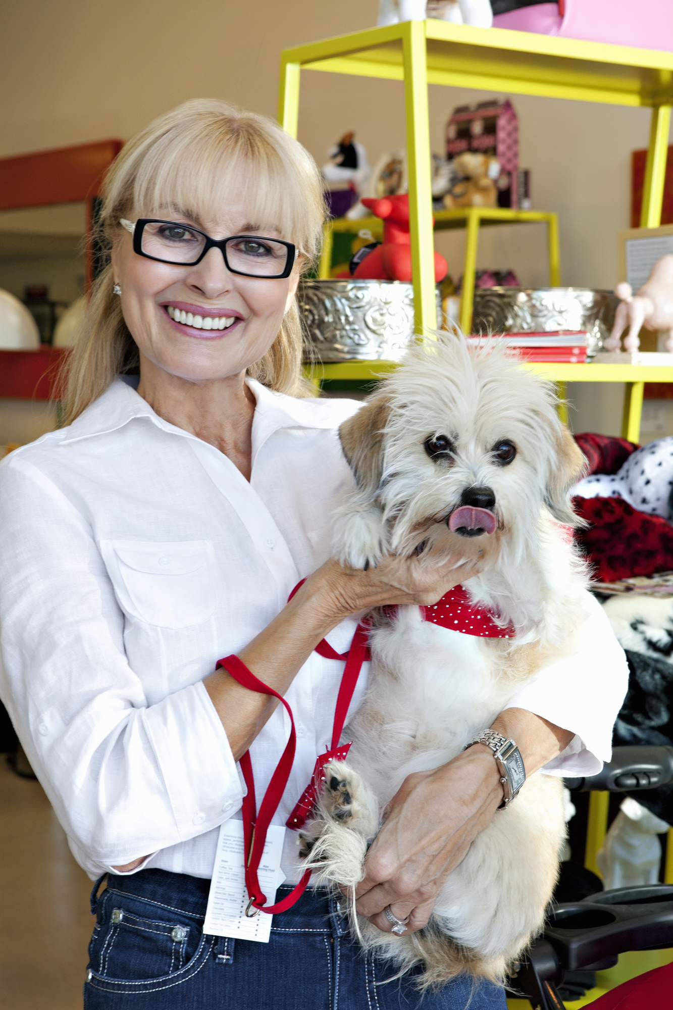 Woman in a white shirt holding a small white dog