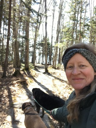 Woman and dogs in New England at pet friendly Wolf's Neck Woods State Park in ME
