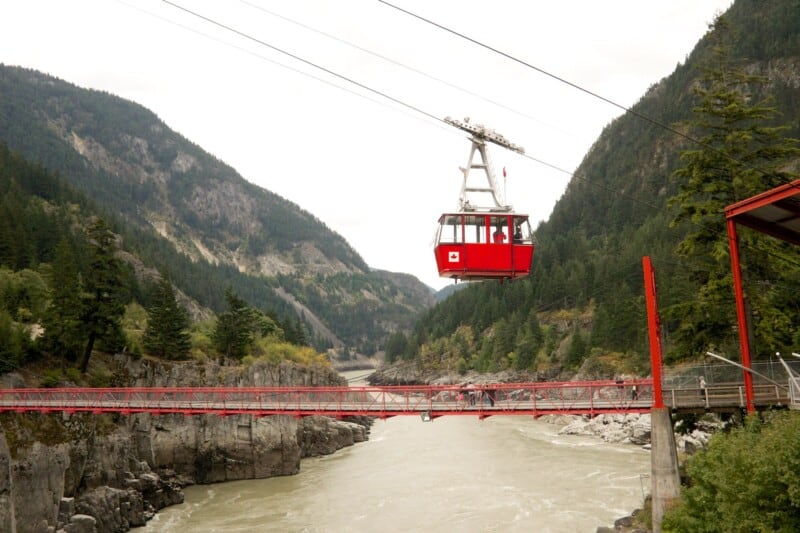 Dog Friendly cable car arriving at Hell's Gate station, hovering over the Hell's Gate Bridge and Fraser River in Vancouver, BC