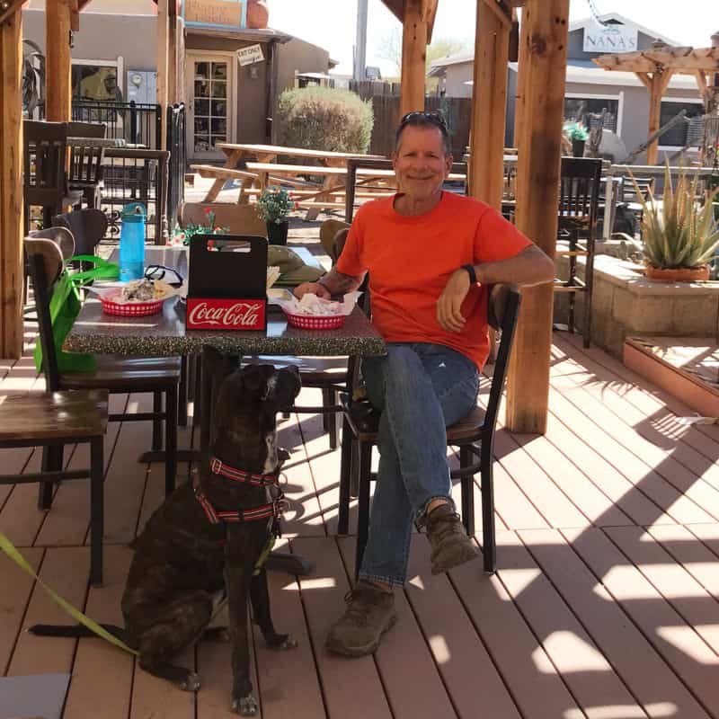 Man and dog sitting on the pet friendly patio at the Pita Patio Grill in Coolidge, AZ