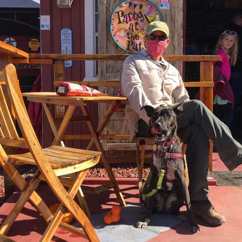 Man and dog sitting at a dog friendly brewery in Sonoita, AZ