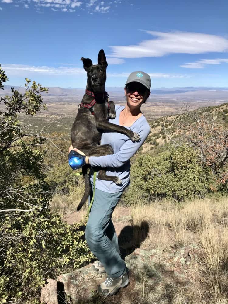 Woman holding dog on a pet friendly trail at Kartchner Caverns State Park near Tucson, AZ
