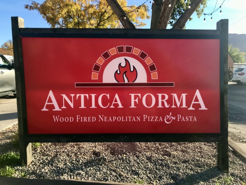 Sign for Antica Forma, a dog friendly restaurant in Moab, UT