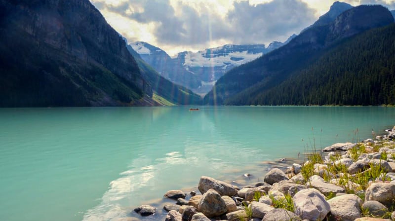 pet friendly banff destination lake louise. Turquoise water surrounded by mountains.