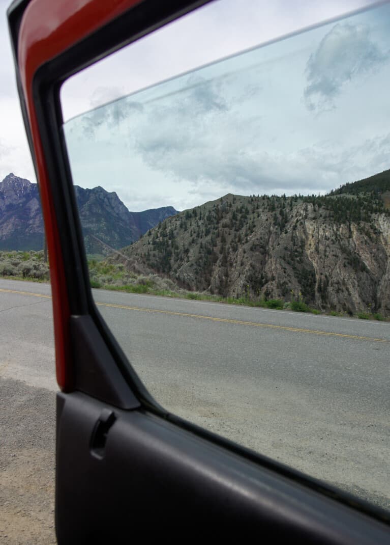 Desert mountains framed by car window driving from Vancouver to Kamloops, near Lillooet, BC.