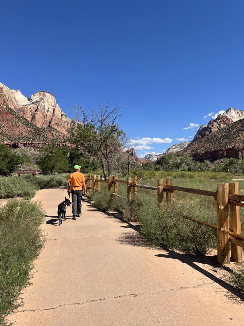 Man walking dog on the pet friendly Pa'rus Trail in Zion National Park, UT