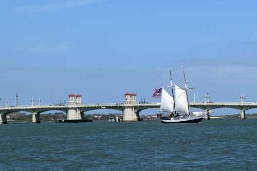 Schooner under sail in front of the Bridge of Lions.