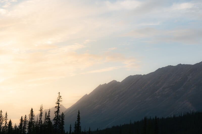 Soft warm sunset light glowing over sheer Jasper mountains.