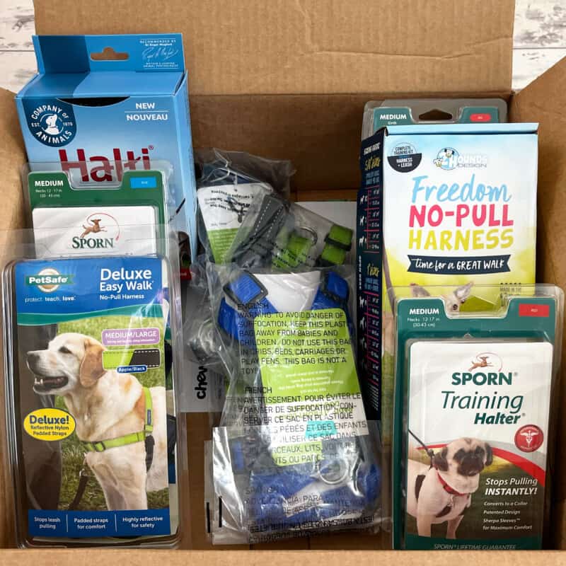 A selection of no-pull dog harnesses in a box