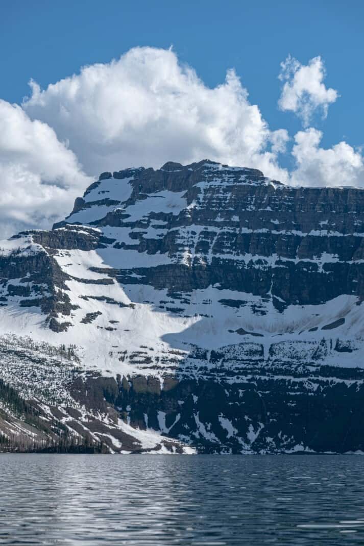 Snowy mountain towering over Cameron Lake in Waterton Lakes National Park.