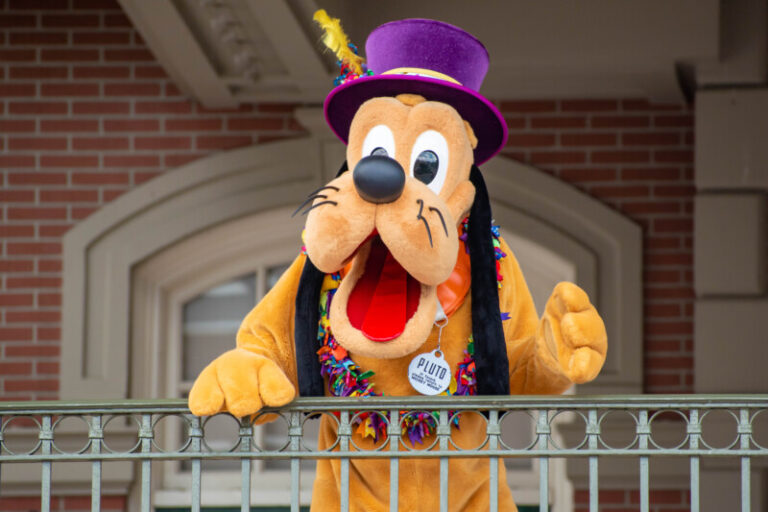 Pluto waving from the balcony at a pet friendly resort at Walt Disney World in Orlando, FL